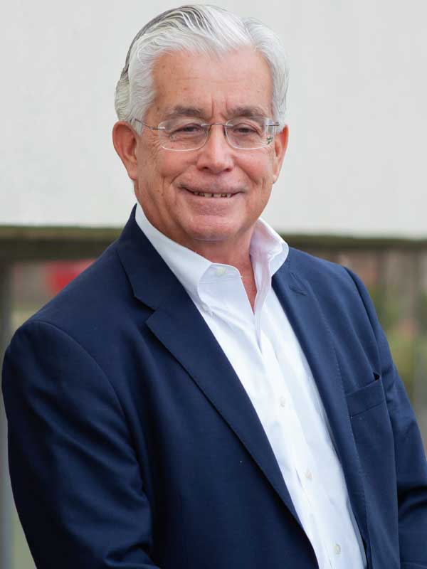 Image of Bill Meier wearing a white dress shirt and navy suit